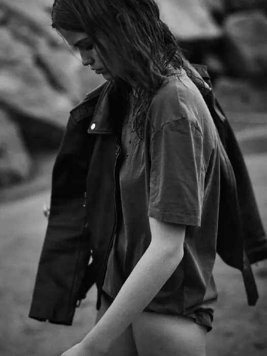 Model in a black jacket, black and white campaign