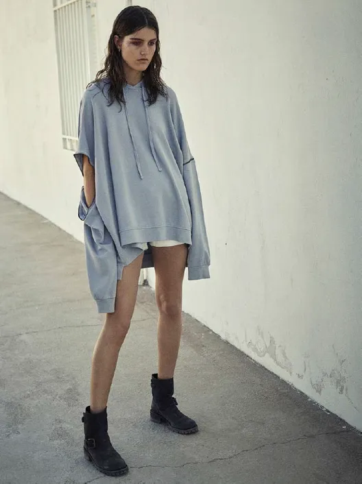 Model in an oversized blue denim shirt dress