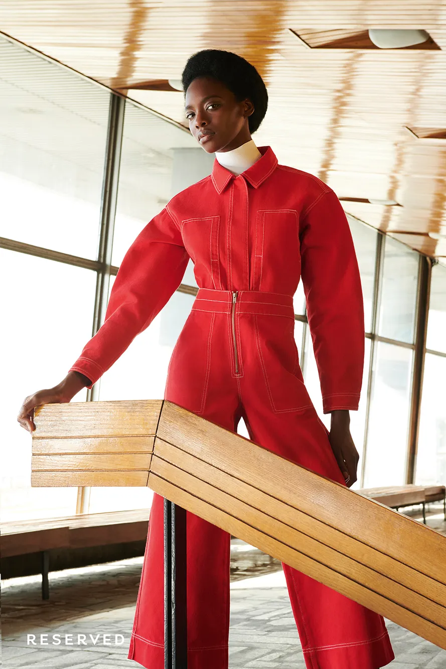 Model in a red utility jumpsuit