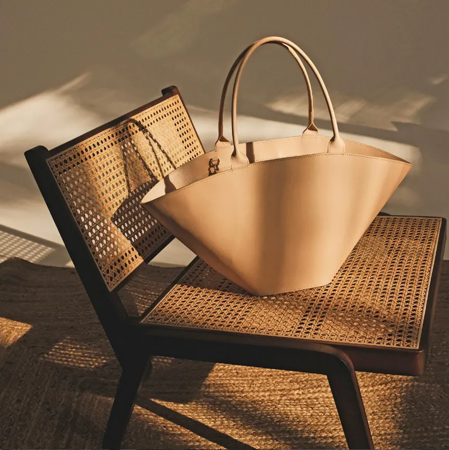 Natural leather basket bag on a rattan chair