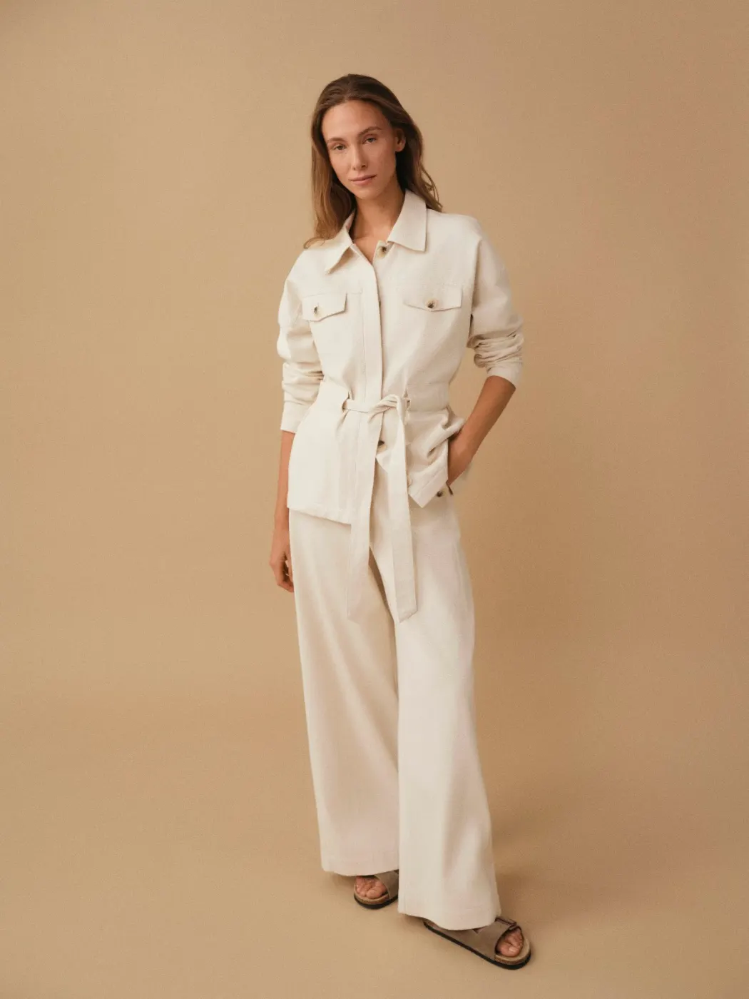 Model in a cream utility shirt and wide trousers