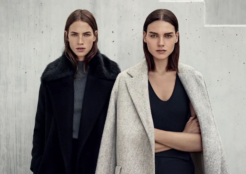 Two models in black and grey coats