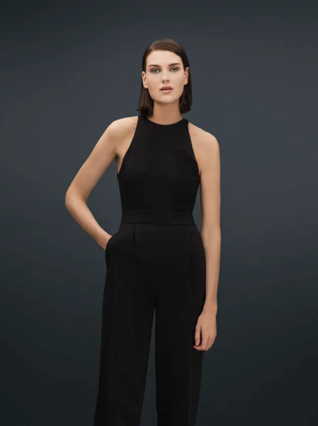 Model in a black halter jumpsuit